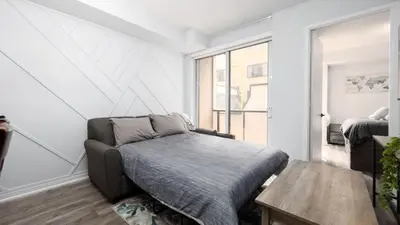 a living room with a couch and a table at Modern 1BR Condo in Church Yonge Corridor in Toronto