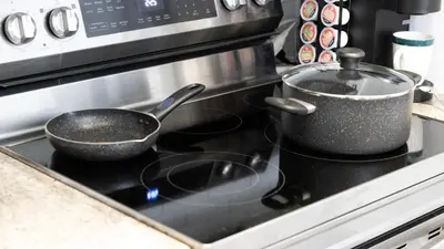 two pots and pans sitting on top of a stove at Modern 1BR Condo in Church Yonge Corridor in Toronto