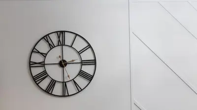 a clock on the side of a white wall at Modern 1BR Condo in Church Yonge Corridor in Toronto