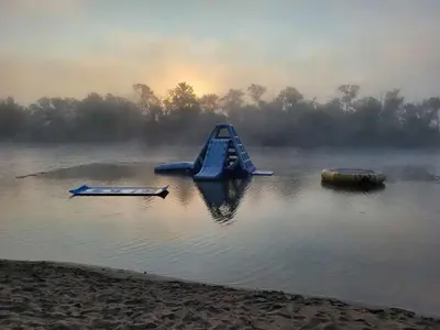 a playground in the middle of a lake with a slide at Wildwood Bunkies in Bailieboro
