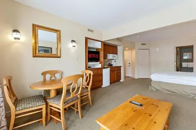 a hotel room with a bed and a table and chairs at Peaceful Escape King Bed and Outdoor Activities in Edgar