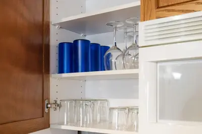 a cabinet filled with glasses on top of a counter at Peaceful Escape King Bed and Outdoor Activities in Edgar