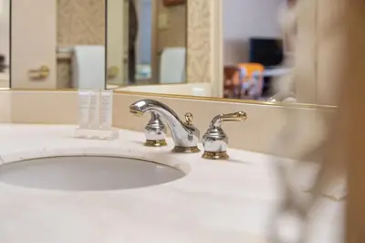 a bathroom sink with a chrome faucet and a mirror at Peaceful Escape King Bed and Outdoor Activities in Edgar