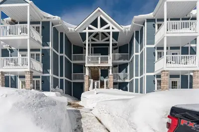 a house with snow in front of it at Peaceful Escape King Bed and Outdoor Activities in Edgar