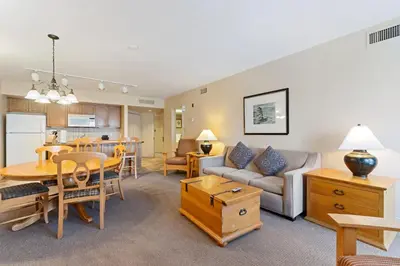 a living room with a couch and a table at Luxury Resort Stay with Pool Jacuzzi and Balcony in Edgar