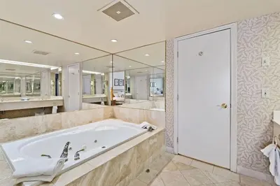 a large bathroom with a tub and mirrors at Luxury Resort Stay with Pool Jacuzzi and Balcony in Edgar