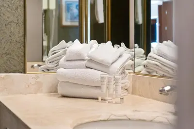a pile of towels sitting on top of a bathroom sink at Luxury Resort Stay with Pool Jacuzzi and Balcony in Edgar