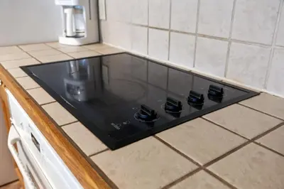 a black stove top on a kitchen counter at Resort Style with Balcony Hot Tub and Full Kitchen in Edgar
