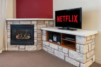 a living room with a tv and a fireplace at Resort Style with Balcony Hot Tub and Full Kitchen in Edgar