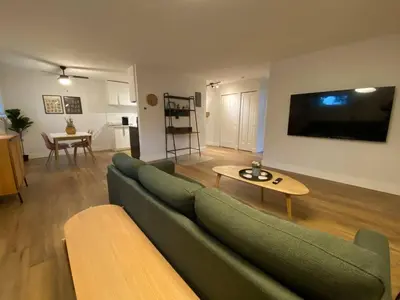 a living room with a green couch and a table at ENTIRE 1 BEDROOM APARTMENT by UW RESEARCH PARK - PS1 in Waterloo