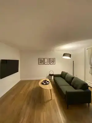 a living room with a green couch and a table at ENTIRE 1 BEDROOM APARTMENT by UW RESEARCH PARK - PS1 in Waterloo