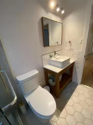 a bathroom with a white toilet and a sink at ENTIRE 1 BEDROOM APARTMENT by UW RESEARCH PARK - PS1 in Waterloo