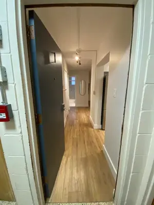 a hallway of an apartment with a door and wooden floors at ENTIRE 1 BEDROOM APARTMENT by UW RESEARCH PARK - PS1 in Waterloo