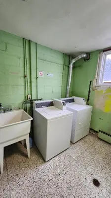 a dirty bathroom with two washing machines and a sink at ENTIRE 1 BEDROOM APARTMENT by UW RESEARCH PARK - PS1 in Waterloo