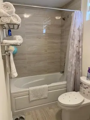 a bathroom with a tub and a toilet and a shower at Luxhome25 in Aurora