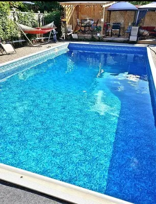 a large swimming pool with blue water at Spacious Pool House 5 Minutes to Elgin Centre in Saint Thomas