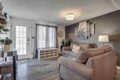 a living room with a couch and a chair at Spacious Pool House 5 Minutes to Elgin Centre in Saint Thomas