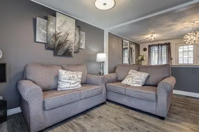 a living room with two chairs and a couch at Spacious Pool House 5 Minutes to Elgin Centre in Saint Thomas