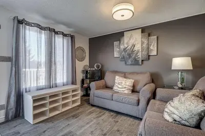 a living room with a couch and a chair at Spacious Pool House 5 Minutes to Elgin Centre in Saint Thomas