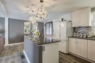 a kitchen with a white refrigerator and a counter top at Spacious Pool House 5 Minutes to Elgin Centre in Saint Thomas