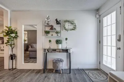 a living room with a table and a mirror at Spacious Pool House 5 Minutes to Elgin Centre in Saint Thomas