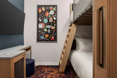 a small bedroom with a bunk bed and a picture on the wall at Hard Rock Hotel London Ontario in London