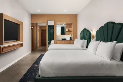 a hotel room with two beds and a television at Hard Rock Hotel London Ontario in London