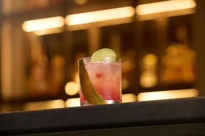 a drink with a lime slice on a table at Hard Rock Hotel London Ontario in London
