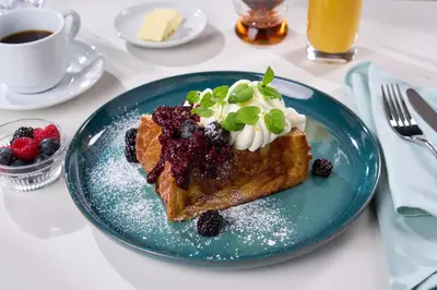 a blue plate with a piece of cake with berries at Hard Rock Hotel London Ontario in London