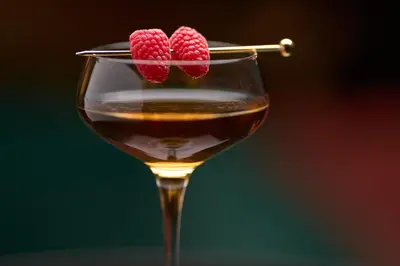a wine glass with two raspberries on top of it at Hard Rock Hotel London Ontario in London