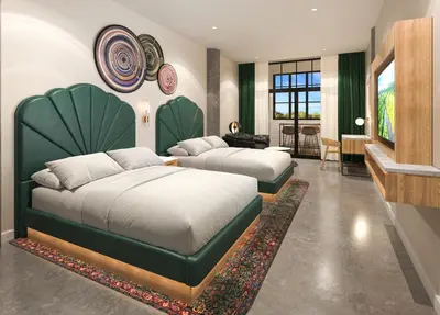 a bedroom with two beds with a large headboard at Hard Rock Hotel London Ontario in London