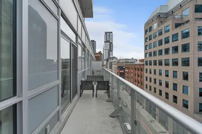 a balcony with a view of a city at 2BR 2BA Suite with Sofa Bed by Financial District in Toronto