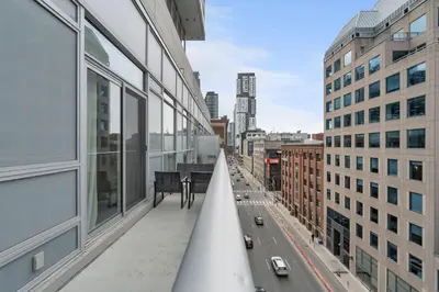 a balcony of a building with a view of a city at 2BR 2BA Suite with Sofa Bed by Financial District in Toronto
