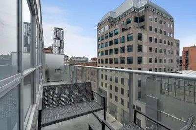 a balcony with a bench on a building at 2BR 2BA Suite with Sofa Bed by Financial District in Toronto