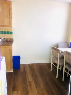 a kitchen with a table and chairs in a room at Earth Tone Suites in Pickering