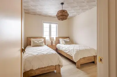 a bedroom with two beds and a ceiling at The California Sunset in St. Catharines