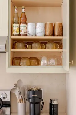 a kitchen with a cupboard filled with lots of dishes at The California Sunset in St. Catharines
