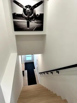 a stairway with a picture of an airplane on the ceiling at Garden Suite with Pool and Sauna in Brampton