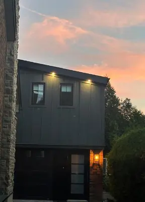 a house with two lights on the roof at sunset at Garden Suite with Pool and Sauna in Brampton