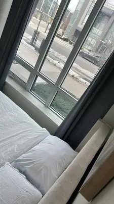 a bed sitting in front of a window at Private Cozy Room in Mississauga