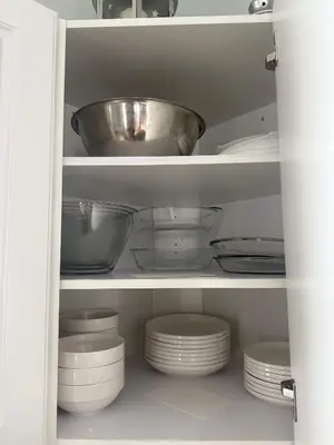 a cupboard filled with dishes and a bowl at The Merlin - 61 Butternut in Cherry Valley