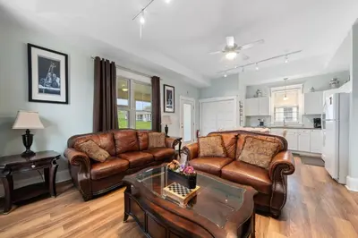 a living room with a couch and a table at The Merlin - 61 Butternut in Cherry Valley