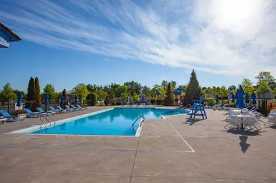 a large swimming pool with chairs at The Balsam - 36 Farm View in Cherry Valley
