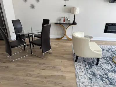 a dining room with a glass table and chairs at Cozy 3 Bedroom Townhome Hyde Park Mall & Western University in London