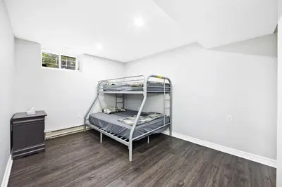 a bedroom with a bunk bed in a room at PRIVATE COTTAGE GETAWAY On LAKE SIMCOE in Brechin