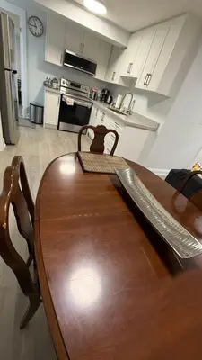 a wooden table and chairs in a kitchen at Brand new 2 bedroom basement apartment in Ajax