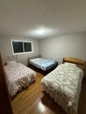 a room with two beds in a room at Affordable Family Room for 4 People-24Hrs Checkin-Next To Downtown,Airport in Kitchener