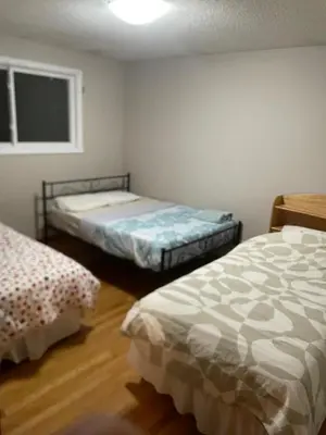 a bedroom with two beds and a window at Affordable Family Room for 4 People-24Hrs Checkin-Next To Downtown,Airport in Kitchener