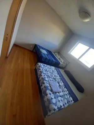 a small bed in a room with a window at Upper Level Cheap Room For 3 People- 24 Hrs Checkin-Walking to Bus,Grocery, Plaza in Kitchener