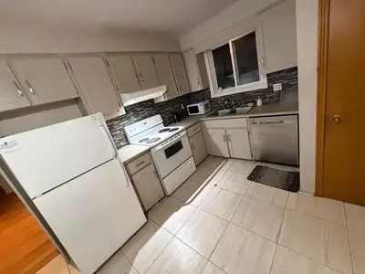 a kitchen with white appliances and white cabinets at Upper Level Cheap Room For 3 People- 24 Hrs Checkin-Walking to Bus,Grocery, Plaza in Kitchener
